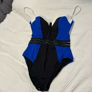 Kenneth Cole one piece swimsuit in blue, black, and white